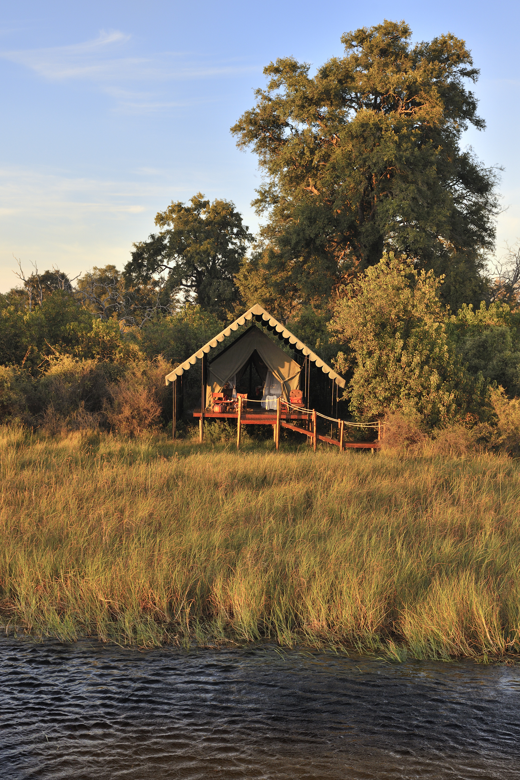 Elevated tented suites blend rustic charm with refined comfort, surrounded by untamed landscapes.